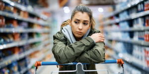 Une jeune femme gênée par l'environnement bruyant en grande distribution
